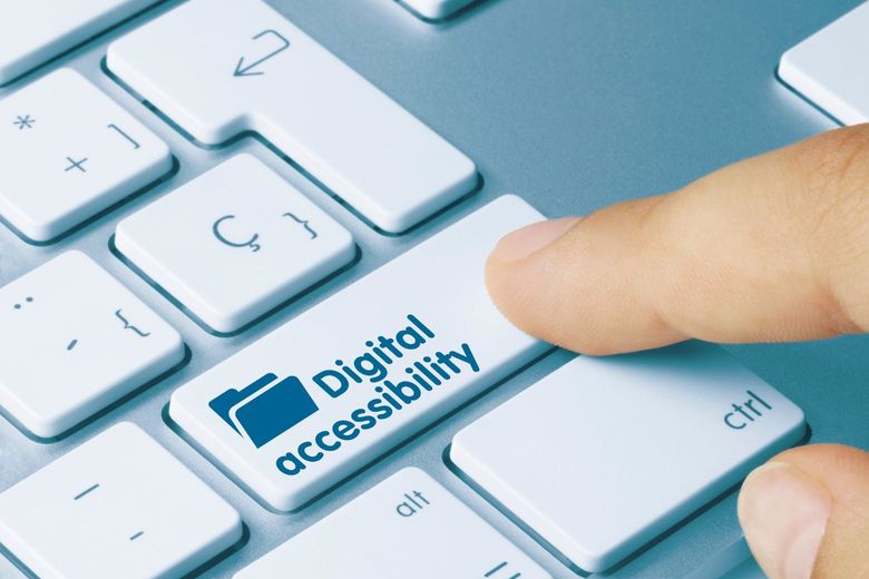 Keyboard with someone pressing a digital accessibility key